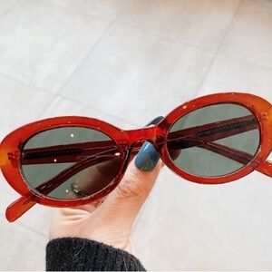 Women’s Red Oval Sunglasses with Dark Lenses
